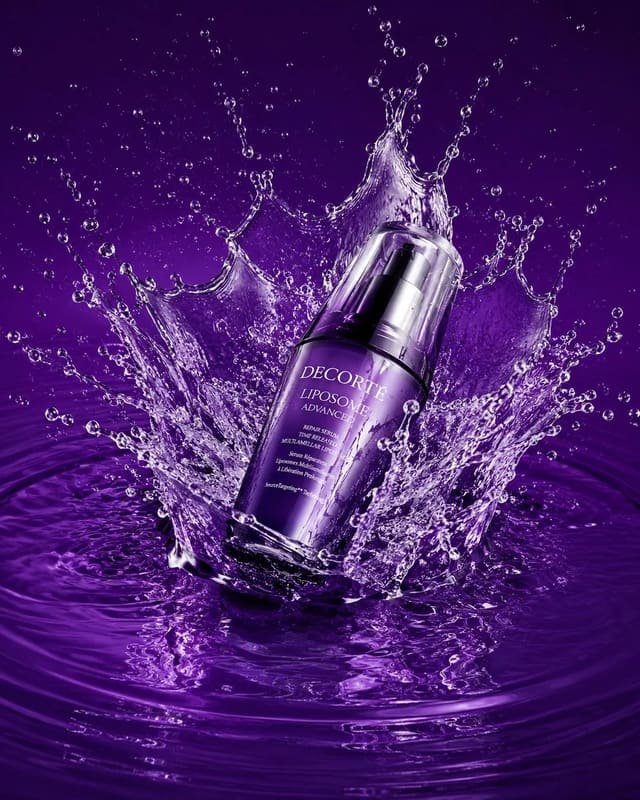 Luxury skincare product ad with dramatic purple water splash