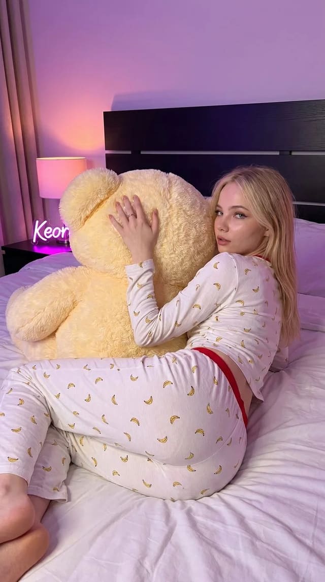 Photorealistic woman hugging a giant teddy bear in bed