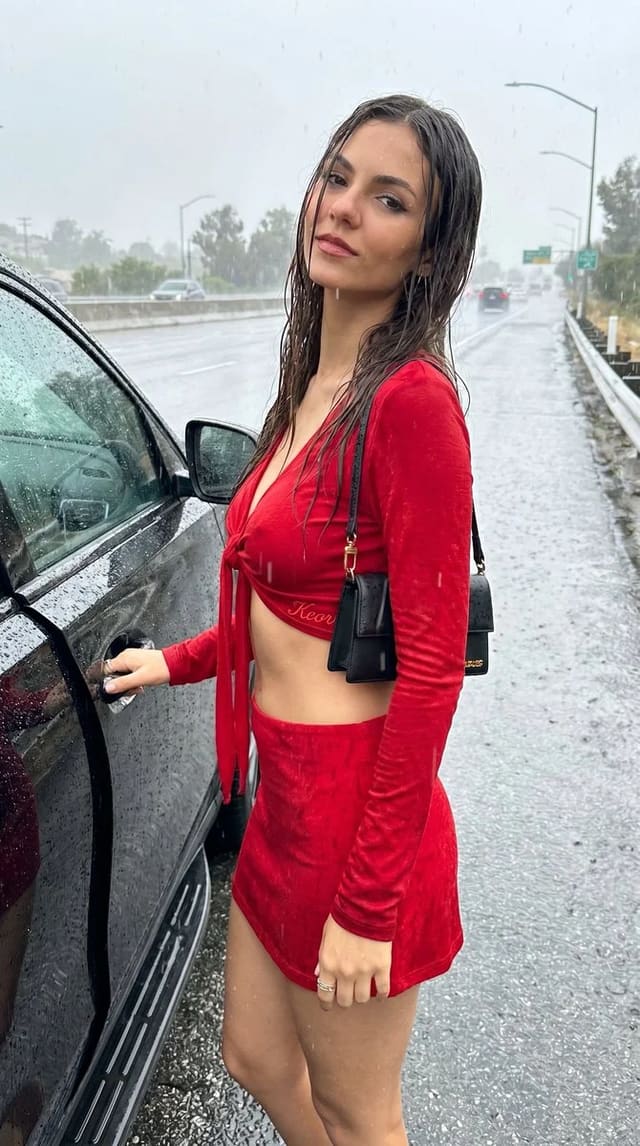 Rainy roadside fashion portrait by car