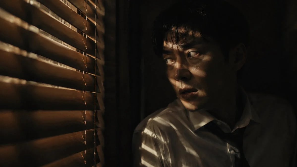 Dark Cinematic Thriller Still of a Man Hiding by Wooden Blinds