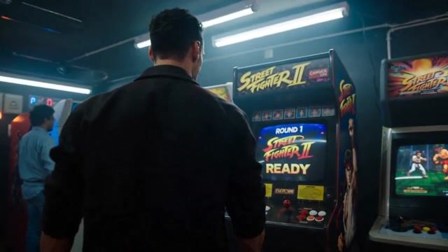 Man Enters an Arcade Universe Through a Retro Cabinet